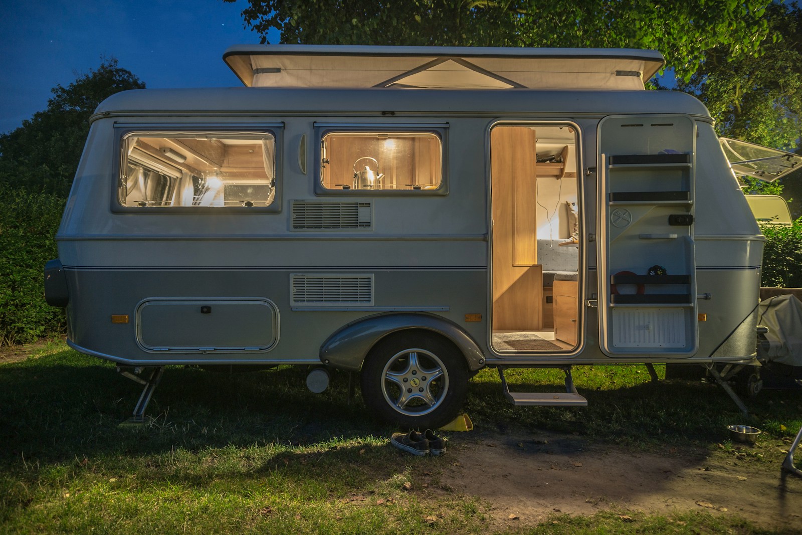 white and brown camper trailer with rv insurance beside tree